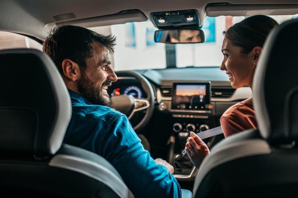 Beautiful,Young,Couple,At,Car,Showroom,Choosing,A,New,Car