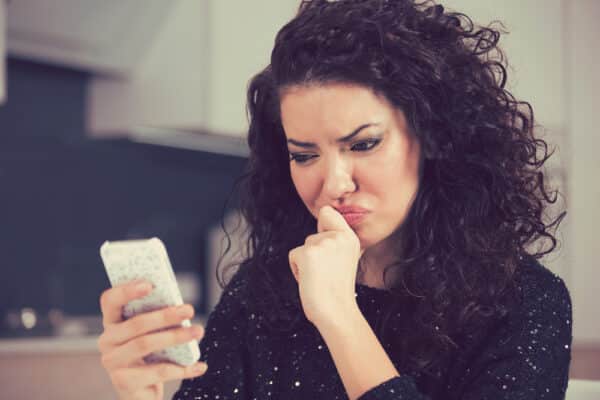 Upset,Confused,Young,Woman,Suing,Mobile,Phone,Reading,Text,Message