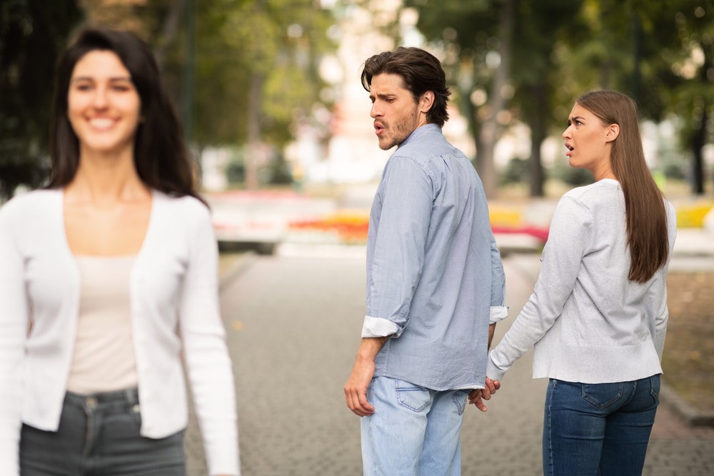 Boyfriend,Looking,At,Other,Girl,Walking,With,His,Irritated,Girlfriend