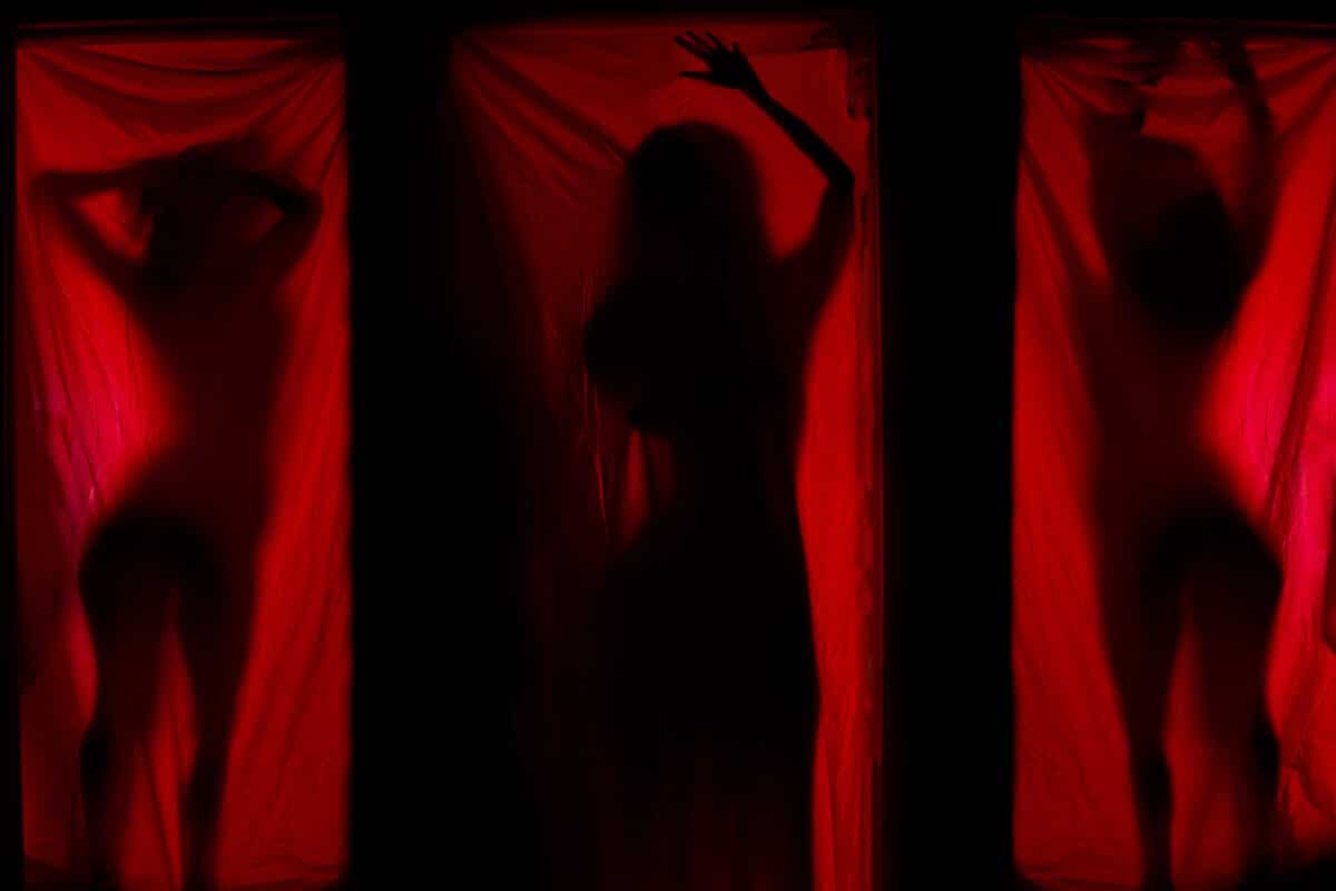 Woman,Behind,Red,Curtains ,Prostitute,Or,Stripper