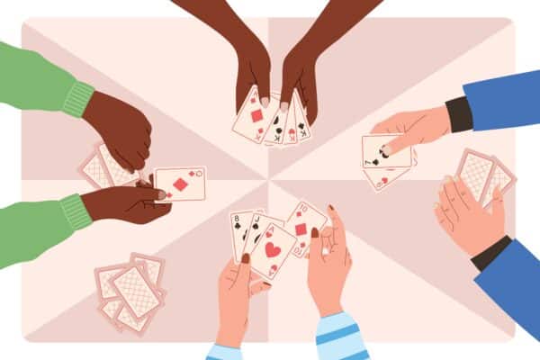 Hands,Of,People,Playing,Cards,,Top,View,On,The,Table