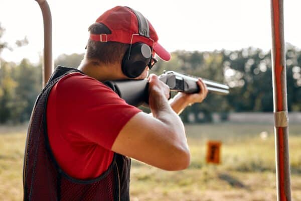 Side,View,On,Caucasian,Man,In,Cap,And,Headset,Shooting