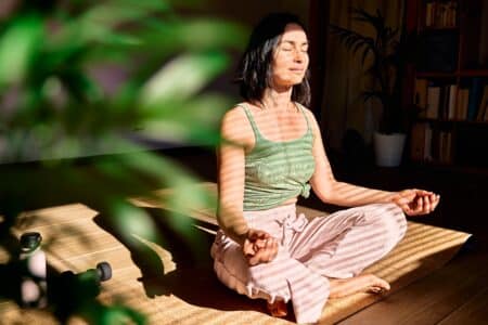 Woman,Practicing,Yoga,And,Meditation,At,Home,Sitting,In,Lotus
