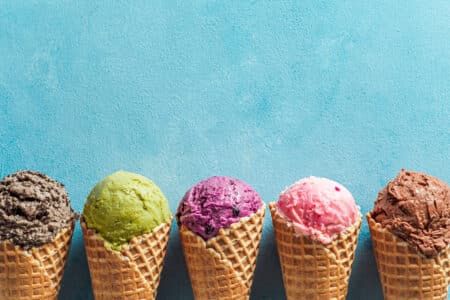 colorful ice cream cones against a textured blue b utc