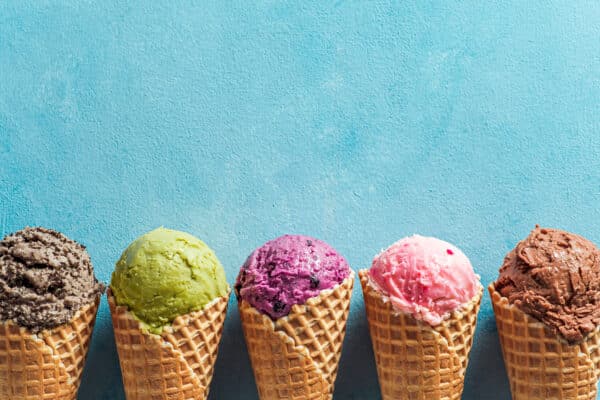 colorful ice cream cones against a textured blue b utc