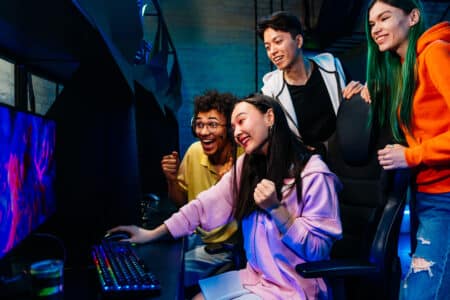 excited gamers cheer in a gaming room utc
