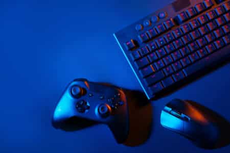 gaming keyboard mouse and controller lit in blue utc
