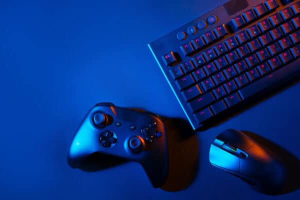 gaming keyboard mouse and controller lit in blue utc