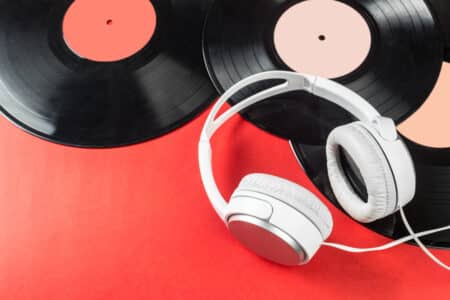 headphones and vinyl records on red background utc