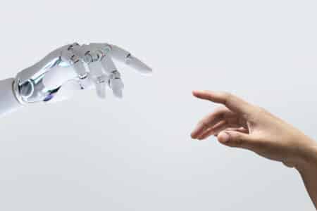robotic hand and human hand reach out utc