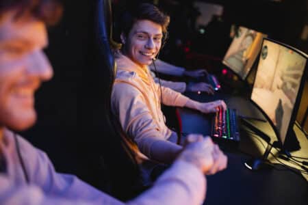 smiling man in headset shaking hand of blurred fri utc