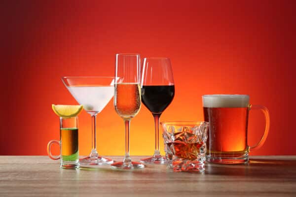 variety of alcoholic drinks on wooden table utc
