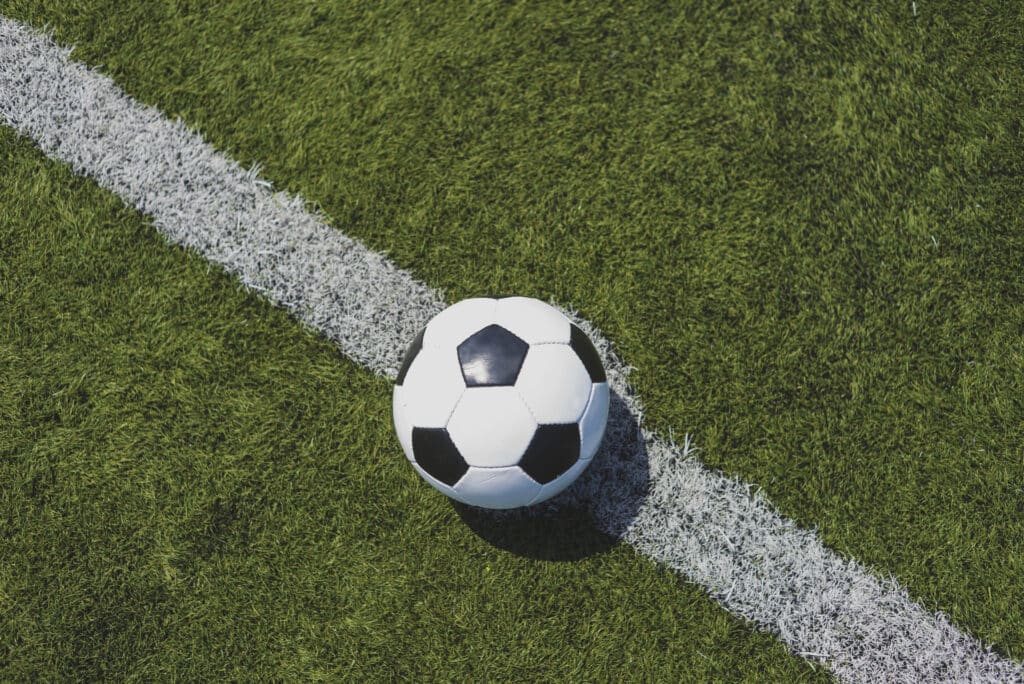 soccer ball on green grass over the white line utc