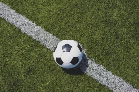 soccer ball on green grass over the white line utc